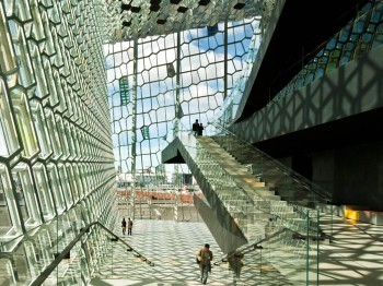 Sunlight-filled atrium space made up of honey-comb style window walls