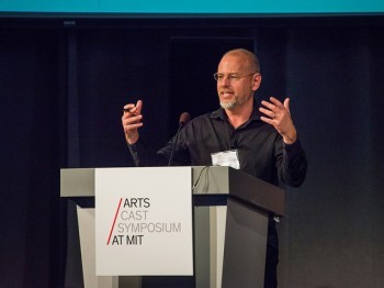 A man speaks at a podium.