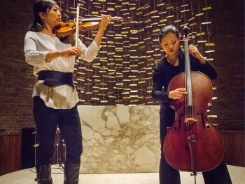 Two women perform cello and violin.