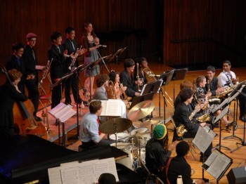 A student jazz ensemble performs on stage.