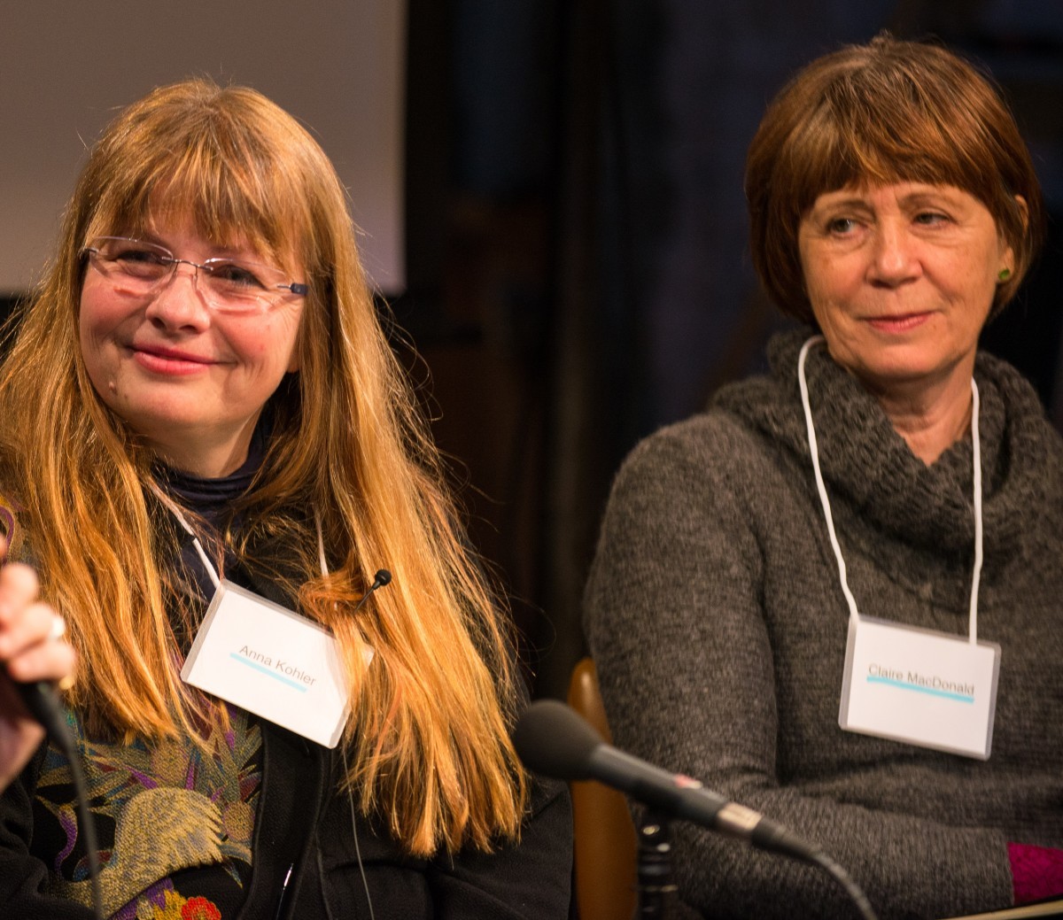 Two women wearing nametags