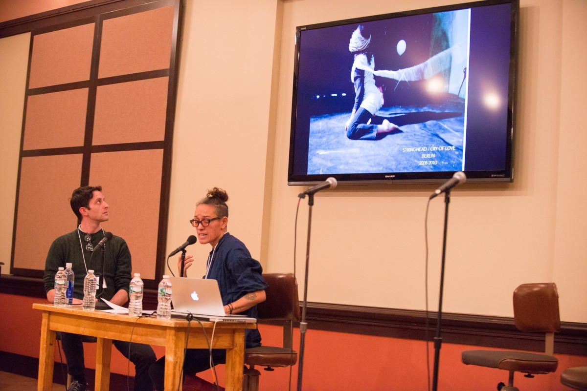 Two people speak at a symposium.