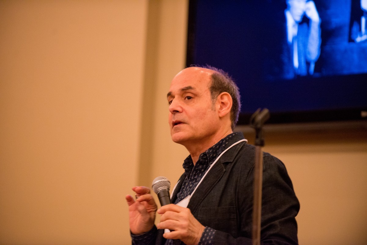 A man speaks into a microphone