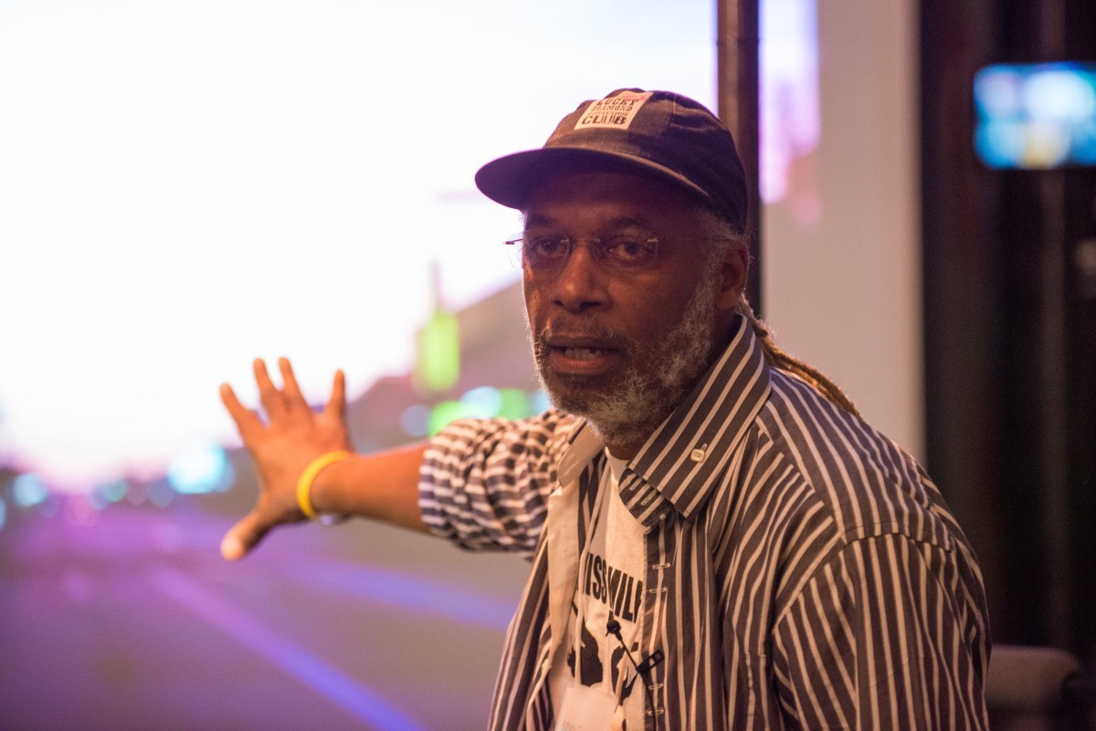 A man speaks at a symposium.