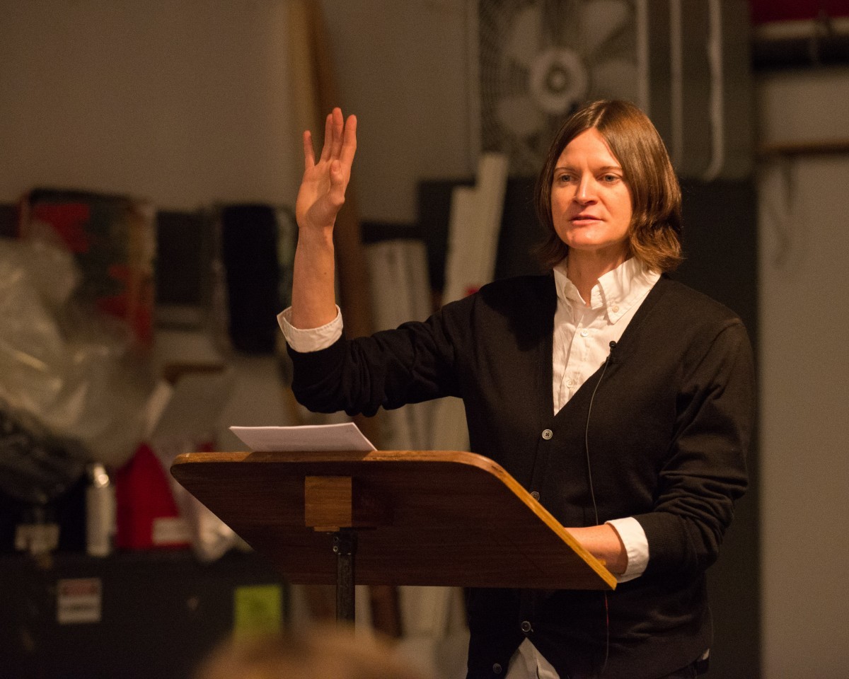 A woman speaks at a symposium.