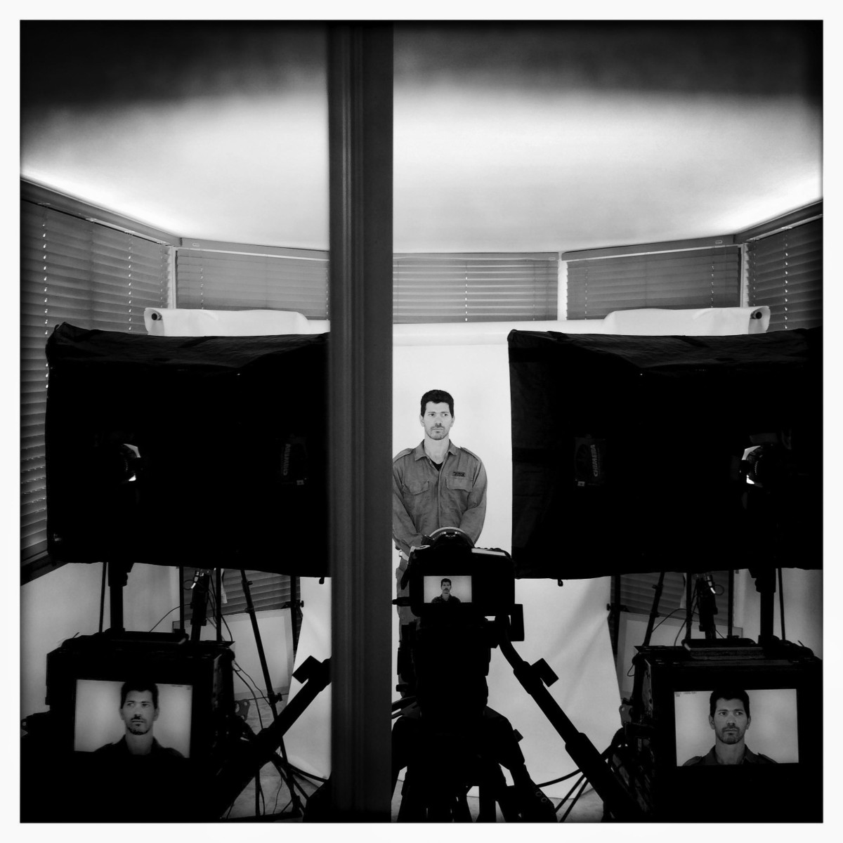 A soldier stands in front of VR camera equipment.