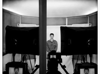 A soldier stands in front of VR camera equipment.