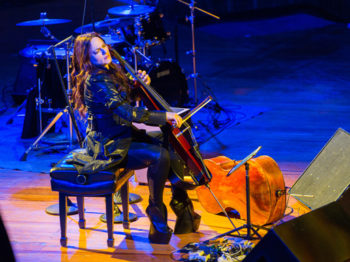 Maya Beiser performs cello on stage.