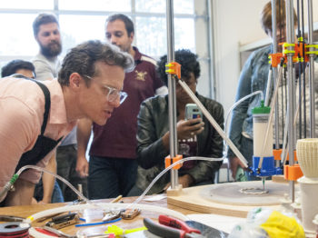 Bryan Czibesz and students observing 3D printer in action. Credit: Jay Pastorello.