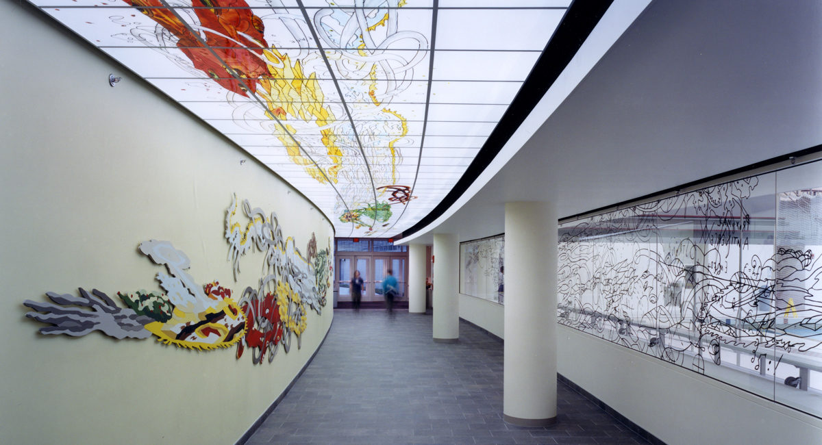 A hallway with colorful art on the ceiling and walls.