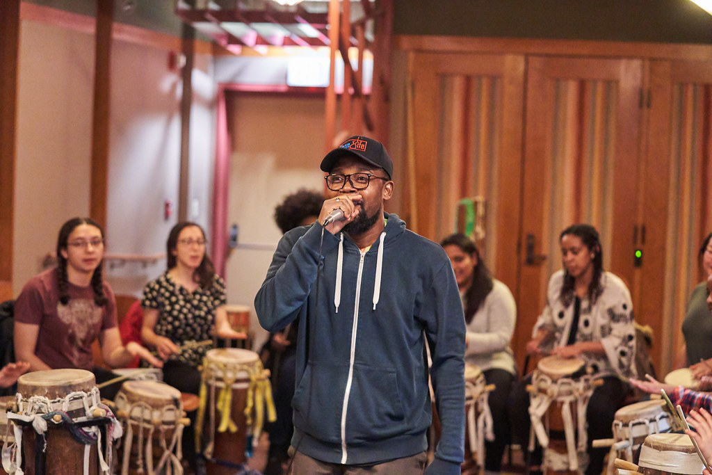 Image: Haitian rapper, poet and singer BIC visits Rambax rehearsal. Credit: Leon Yim.