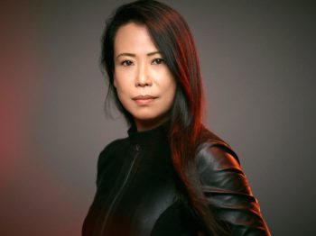 Pianist Maki Namekawa in a leather jacket looking into the camera.