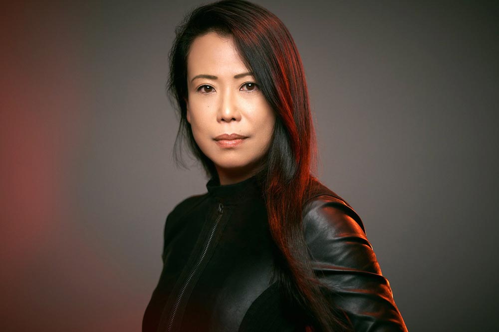 Pianist Maki Namekawa in a leather jacket looking into the camera.